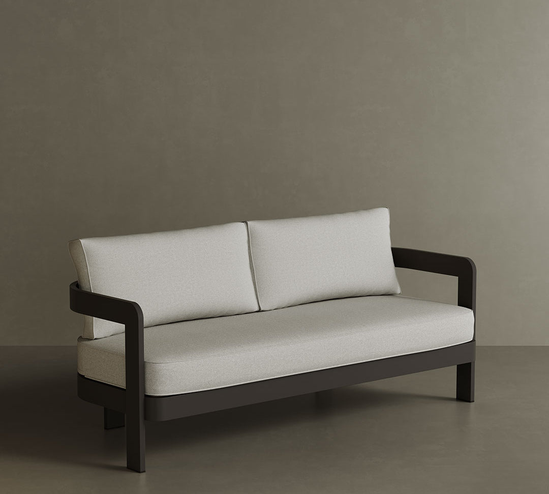 A modern N3 three-seater sofa in Kohl Bone canvas, featuring soft, durable fabric with a refined neutral tone. The sleek aluminium frame offers both strength and elegance, creating a contemporary look. Its versatile colour and clean design make it an ideal addition to any outdoor or indoor space, providing a sophisticated and comfortable seating option.
