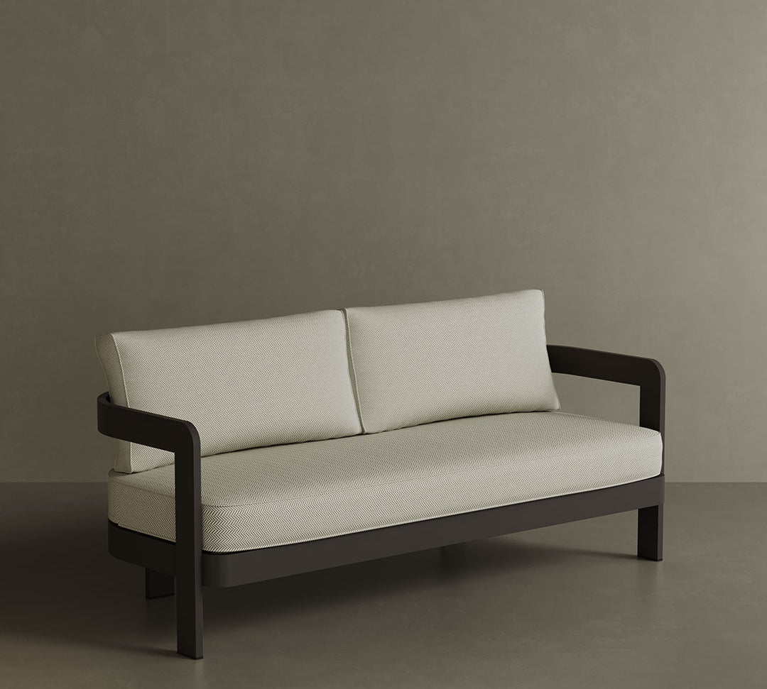 A luxurious N3 three-seater sofa in Kohl Pearl Herringbone, featuring a soft, textured fabric with a sophisticated herringbone pattern. The sleek aluminium frame offers modern durability, while the rich, dark colour adds depth and elegance. Its refined design makes it an ideal addition to any contemporary outdoor or indoor space, providing both style and comfort.