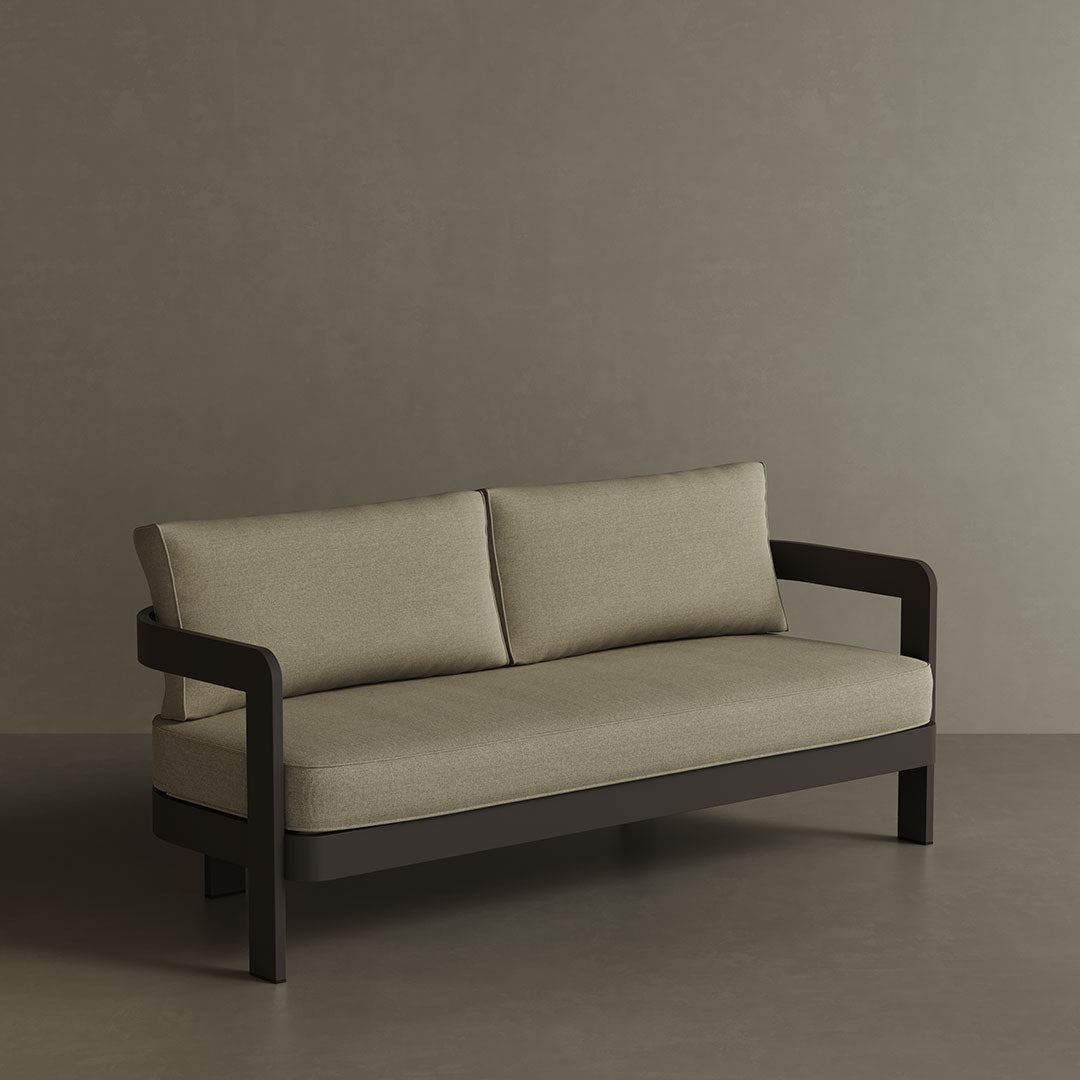 A contemporary N3 three-seater sofa in Kohl Sand canvas, featuring soft, durable fabric and a sleek aluminium frame. The sofa’s warm, neutral colour and modern design create an inviting and sophisticated look, making it a perfect addition to any outdoor space for both comfort and style.