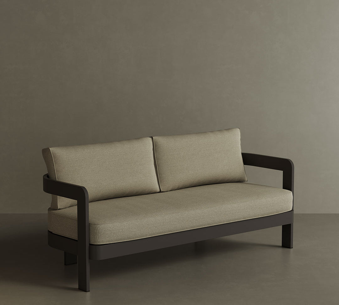 A contemporary N3 three-seater sofa in Kohl Sand canvas, featuring soft, durable fabric and a sleek aluminium frame. The sofa’s warm, neutral colour and modern design create an inviting and sophisticated look, making it a perfect addition to any outdoor space for both comfort and style.