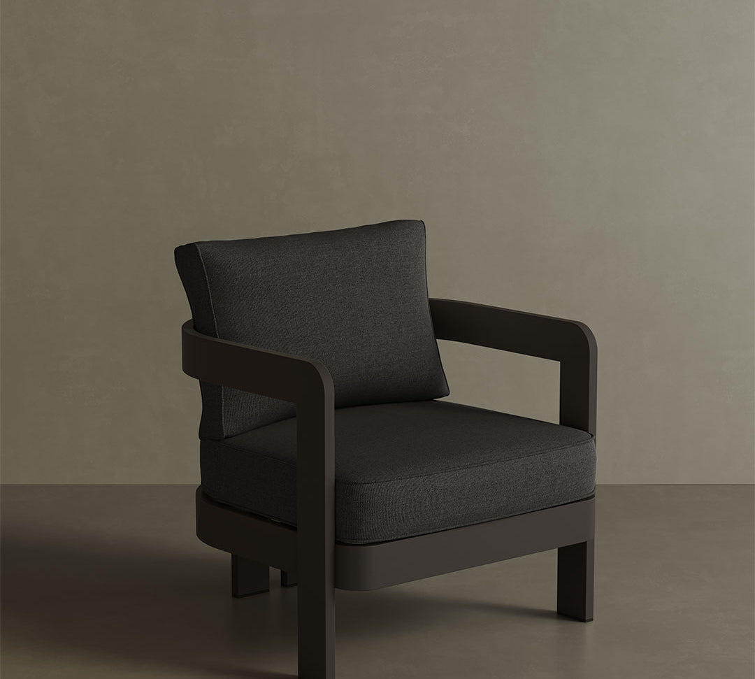 A sleek N3 Kohl Shadow canvas lounge chair, featuring soft, durable fabric in a rich Kohl Shadow colour. The chair's modern design and sturdy frame offer both comfort and elegance, making it a perfect addition to any outdoor or indoor lounge area. Its deep, dark tone adds sophistication and versatility to the space.