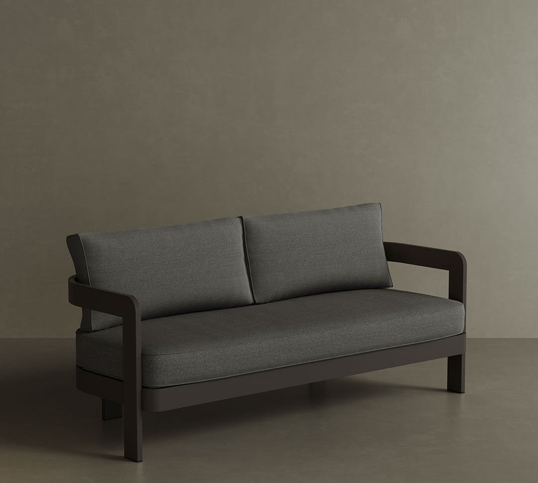 A luxurious three-seater sofa in Smoke Weave, featuring a modern, sophisticated design with soft, textured fabric. The sleek, contemporary lines and comfortable seating make it the perfect centrepiece for any outdoor space, offering both style and relaxation. Its versatile colour and premium construction ensure it blends seamlessly into a variety of outdoor settings.