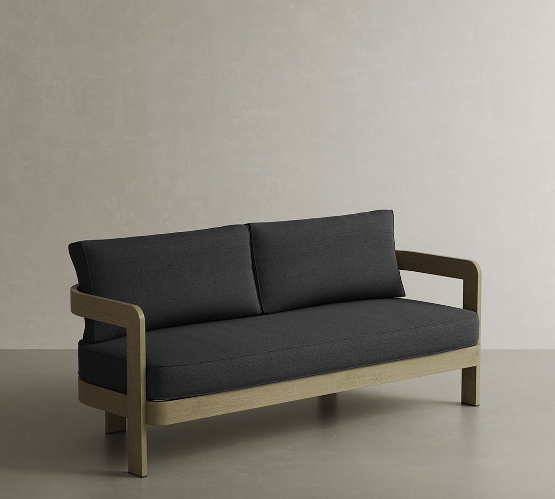 N3 Three-Seater Sofa in Shadow Canvas, showcasing a rich, muted grey fabric with a subtle texture. The sofa’s clean, angular lines are contrasted by its plush seating, creating a sophisticated yet inviting atmosphere. Its sleek, durable frame elevates any space with a perfect blend of modern luxury and understated elegance.
