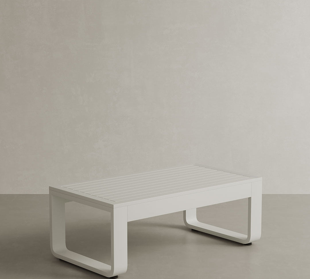 A luxurious stone-coloured outdoor coffee table with a sleek aluminium frame. The table combines the natural elegance of stone with the durability and modern appeal of the aluminium frame. Its neutral, stone-coloured surface adds sophistication to any outdoor space, while the sturdy frame ensures lasting quality and support, making it a stylish focal point for patios or gardens.