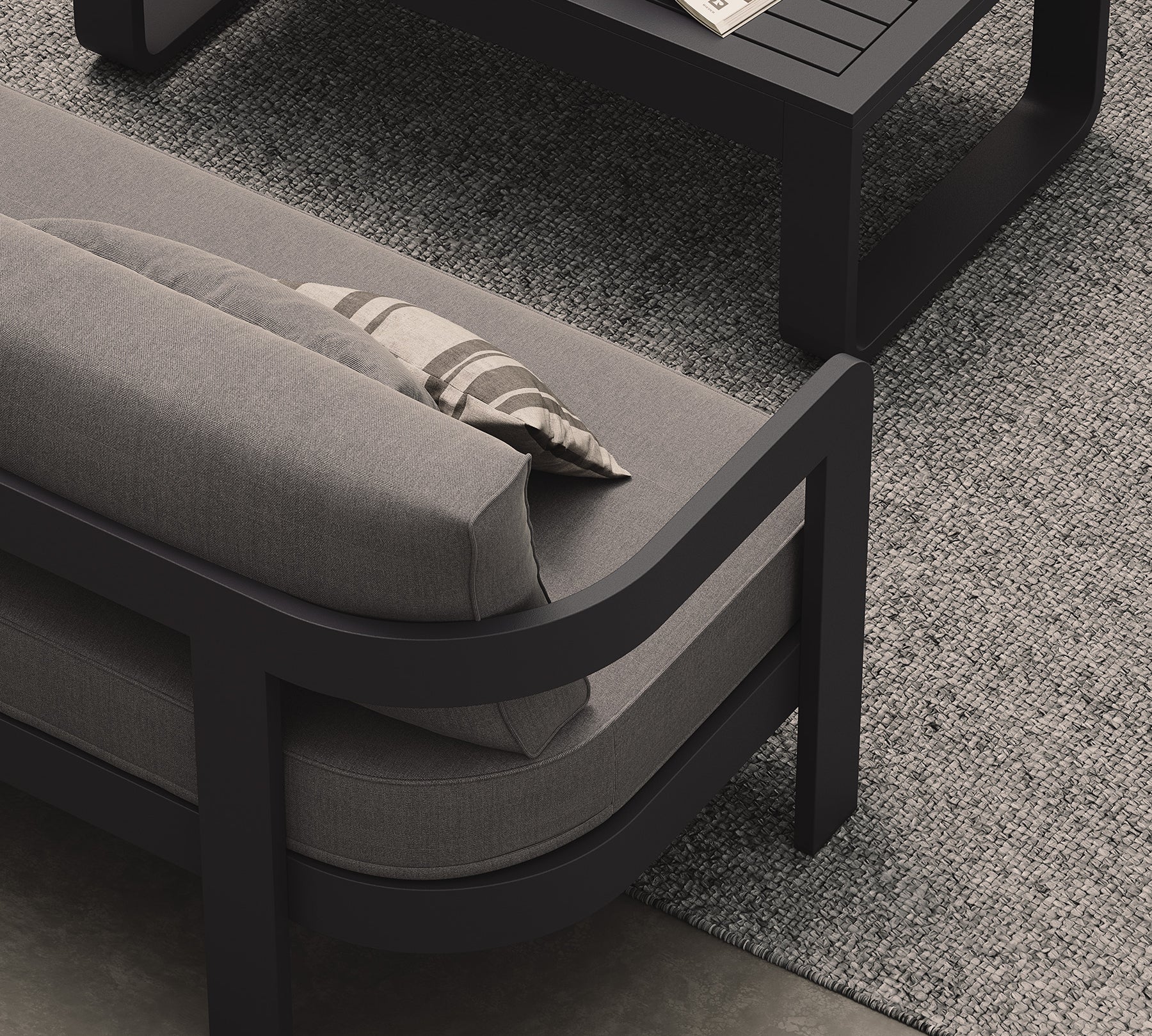A luxurious three-seater sofa in Smoke Weave, featuring a contemporary design with soft, textured fabric. Styled with a sleek aluminium Kohl coffee table and a soft Fog rug, the sofa serves as the centerpiece of this modern outdoor setting. The coffee table’s minimalist design and the rug’s subtle tones complement the sofa, enhancing the overall sophisticated and inviting atmosphere.