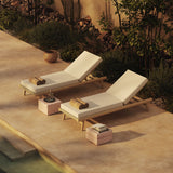 N1 light teak sun loungers and red travertine side tables
