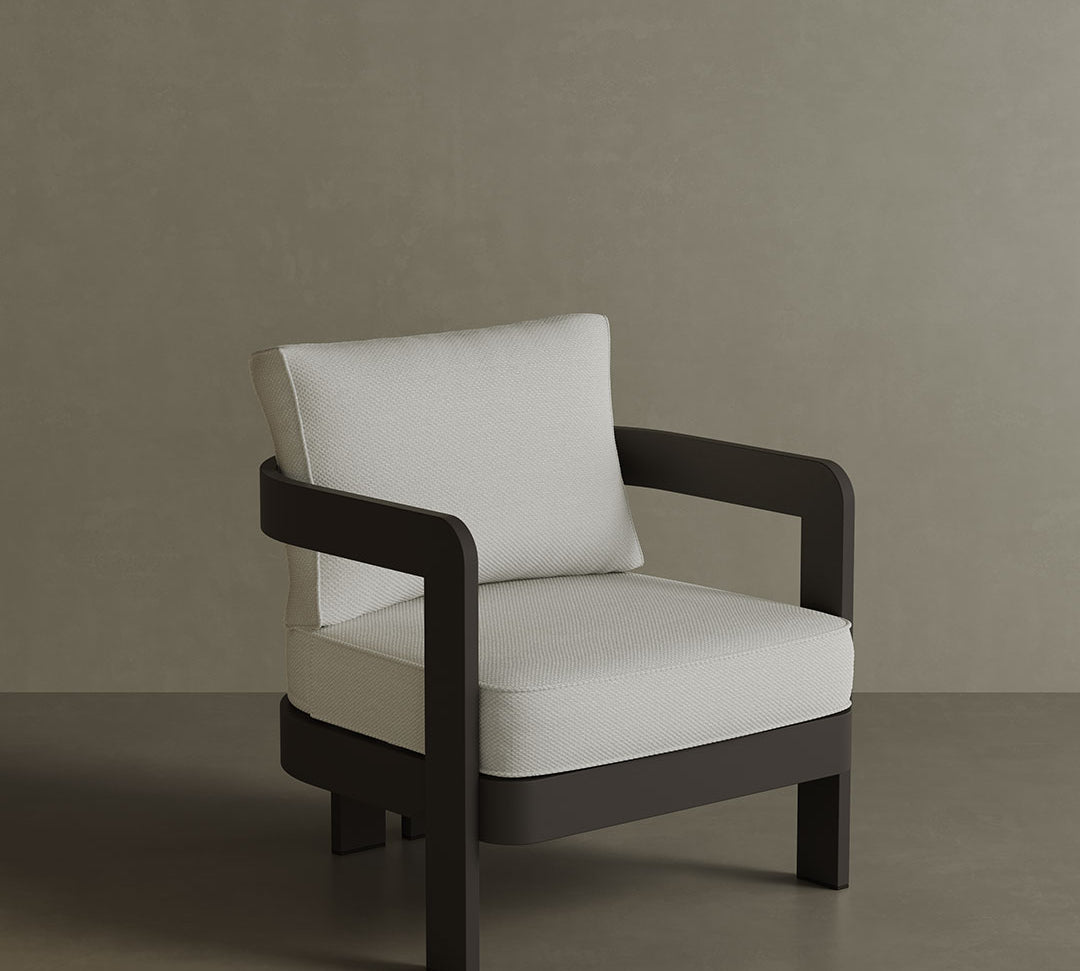N3 Lounge Chair in Kohl Cirrus Textured Weave, featuring soft, durable fabric with a unique textured weave in a deep Kohl colour. The chair is supported by a sleek aluminium frame, offering a contemporary design that combines comfort, style, and durability for both indoor and outdoor spaces.