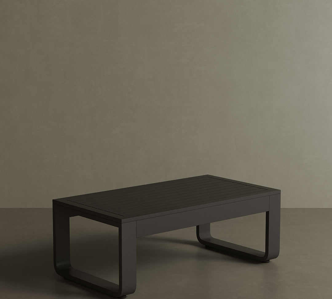 A luxury, kohl-coloured aluminium outdoor table with a modern, dark aesthetic. Featuring clean lines and a smooth matte finish, this sleek table exudes sophistication and contemporary style. Its sturdy yet lightweight design makes it the perfect addition to any chic, outdoor dining or lounge space.