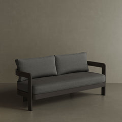 A luxurious three-seater sofa in Smoke Weave, featuring a modern, sophisticated design with soft, textured fabric. The sleek, contemporary lines and comfortable seating make it the perfect centrepiece for any outdoor space, offering both style and relaxation. Its versatile colour and premium construction ensure it blends seamlessly into a variety of outdoor settings.