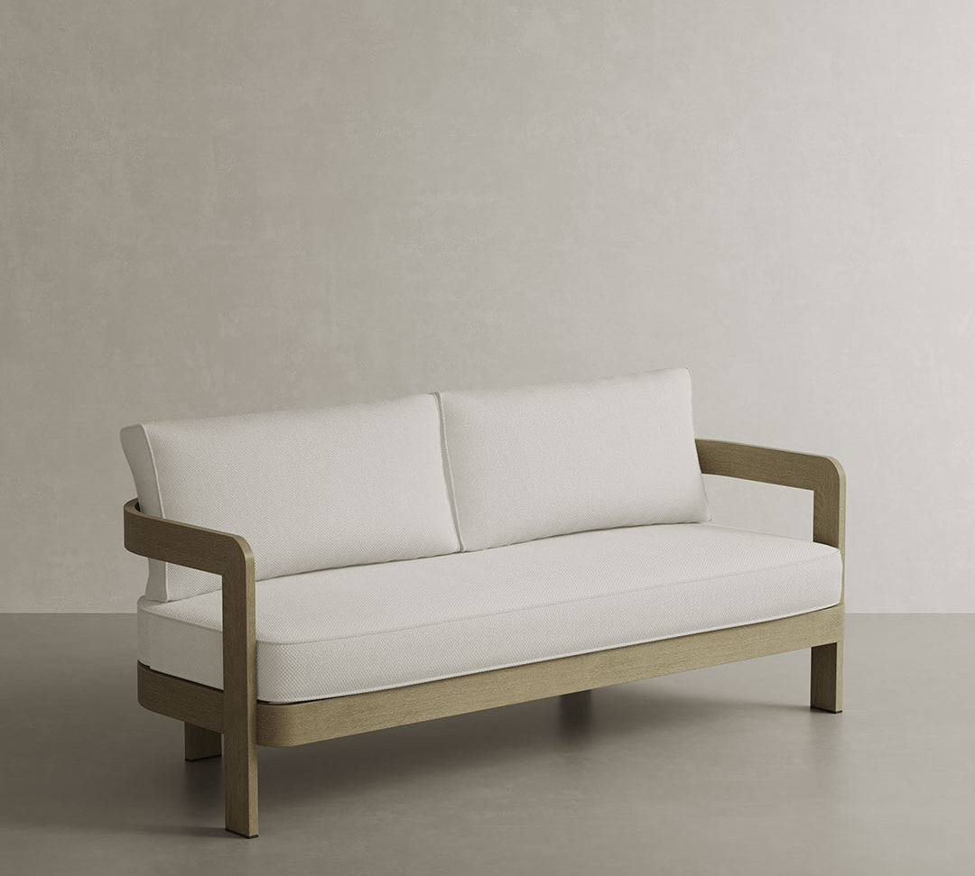 N3 Oak Cirrus Textured Weave Sofa, showcasing a soft, weather-resistant fabric with a subtle textured weave in a light oak hue. The sofa’s contemporary design is complemented by a strong, minimalist frame, blending comfort and sophistication to create a statement piece perfect for both indoor and outdoor settings.