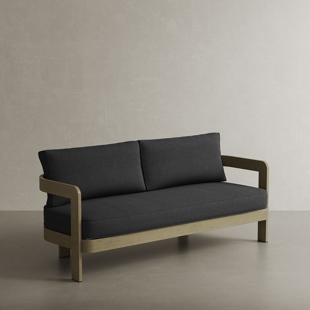 N3 Three-Seater Sofa in Shadow Canvas, showcasing a rich, muted grey fabric with a subtle texture. The sofa’s clean, angular lines are contrasted by its plush seating, creating a sophisticated yet inviting atmosphere. Its sleek, durable frame elevates any space with a perfect blend of modern luxury and understated elegance.