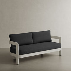 A stylish N3 three-seater sofa in Stone Shadow canvas, featuring a contemporary design with soft, durable fabric. The sofa is supported by a sleek aluminium frame, ensuring both strength and elegance. Its neutral stone colour and modern aesthetic make it a perfect addition to any outdoor space, offering comfort and sophistication.