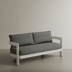 A stylish N3 three-seater sofa in stone smoke weave, featuring a modern design with soft, textured fabric. The sofa is supported by a durable aluminium frame, offering a perfect blend of elegance and strength. Its neutral stone colour and contemporary aesthetic make it an ideal addition to any outdoor space, providing both comfort and sophistication.