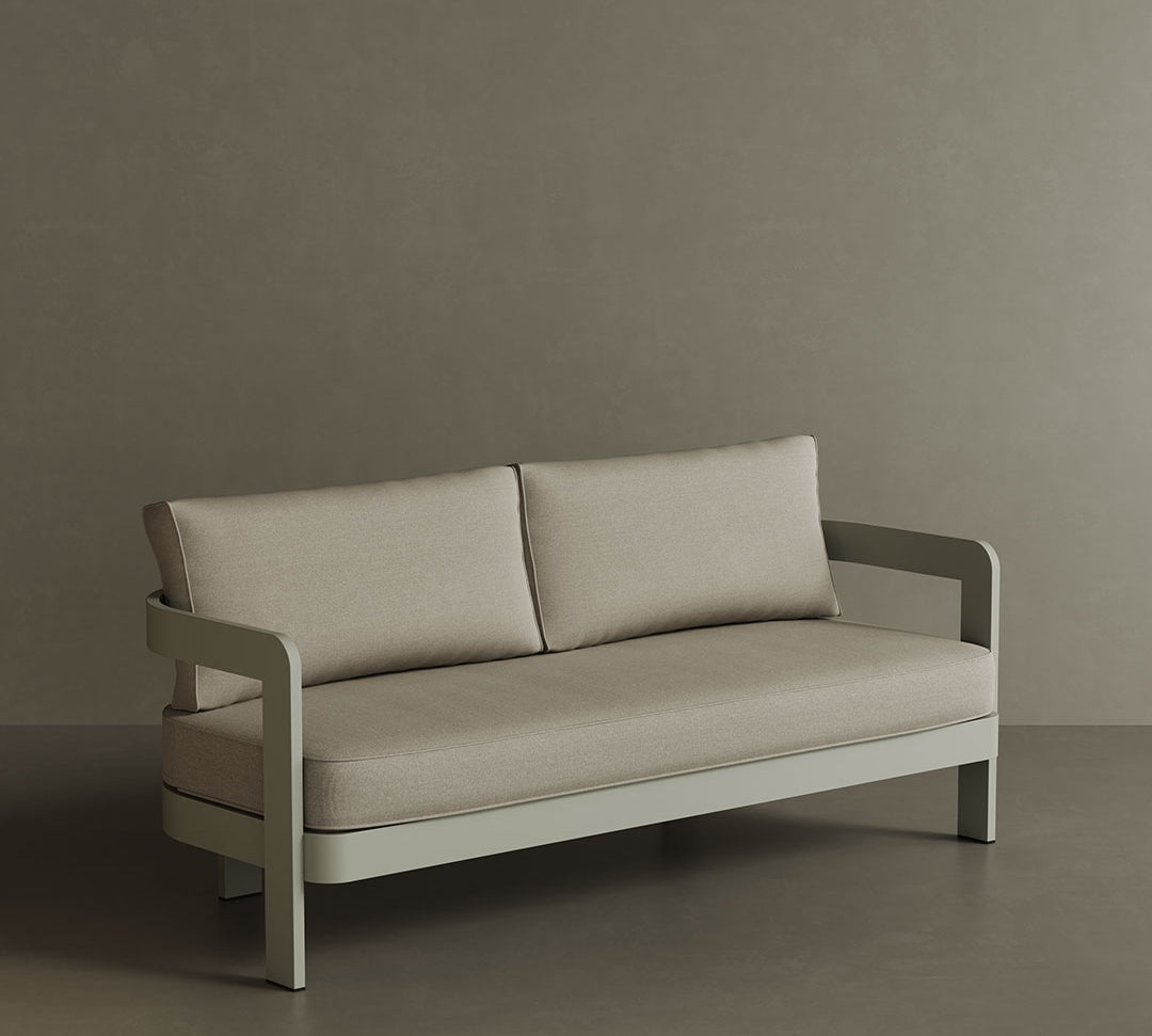 A stylish N3 three-seater sofa in Taupe Sand canvas, showcasing a smooth, durable fabric with a minimalist design. The sofa’s subtle taupe shade and contemporary silhouette make it a perfect choice for enhancing any outdoor area. Built with a robust aluminium frame, it combines comfort and long-lasting elegance.