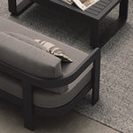 A luxurious three-seater sofa in Smoke Weave, featuring a contemporary design with soft, textured fabric. Styled with a sleek aluminium Kohl coffee table and a soft Fog rug, the sofa serves as the centerpiece of this modern outdoor setting. The coffee table’s minimalist design and the rug’s subtle tones complement the sofa, enhancing the overall sophisticated and inviting atmosphere.