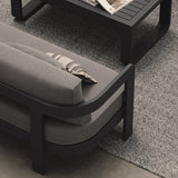 A luxurious three-seater sofa in Smoke Weave, featuring a contemporary design with soft, textured fabric. Styled with a sleek aluminium Kohl coffee table and a soft Fog rug, the sofa serves as the centerpiece of this modern outdoor setting. The coffee table’s minimalist design and the rug’s subtle tones complement the sofa, enhancing the overall sophisticated and inviting atmosphere.